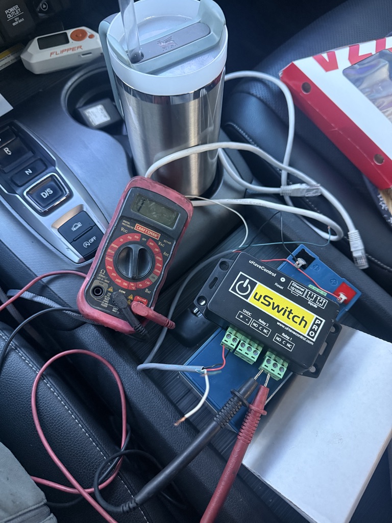 Access-control relay equipment and a multimeter being used for electrical diagnostics