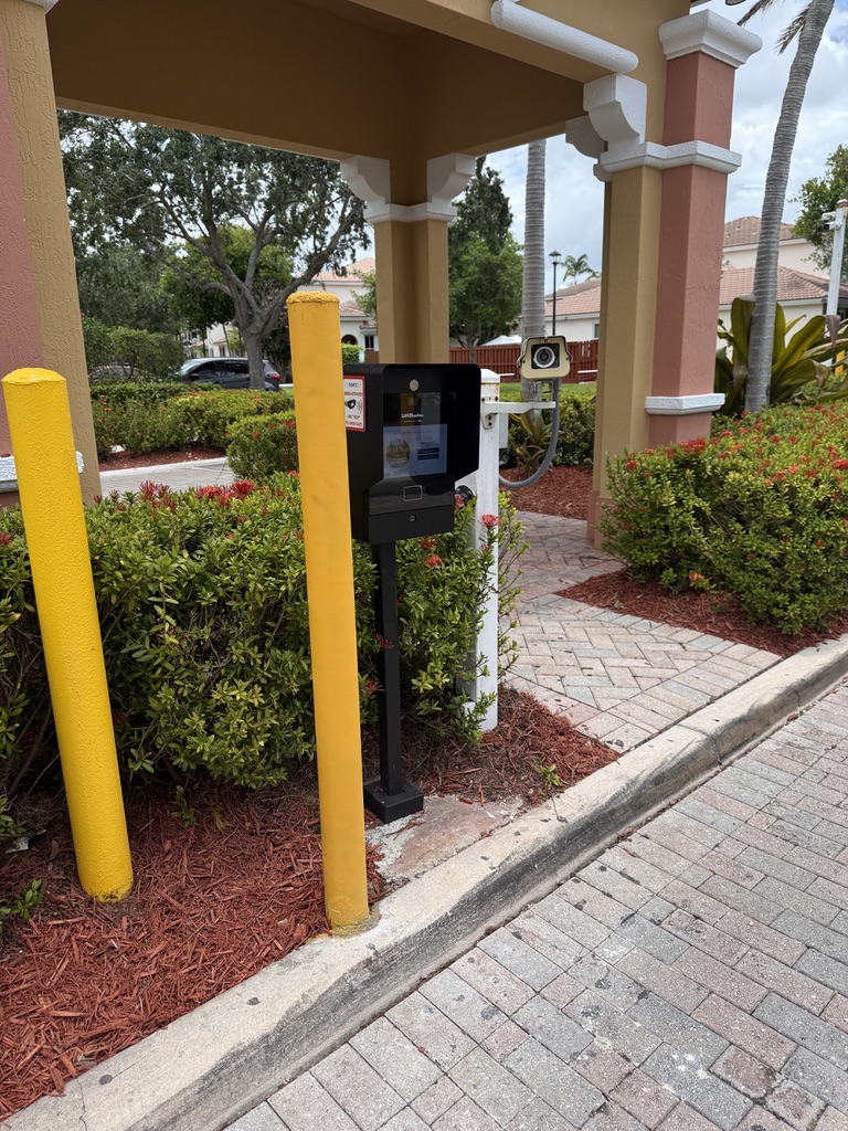 Community callbox and camera protected by two yellow bollards