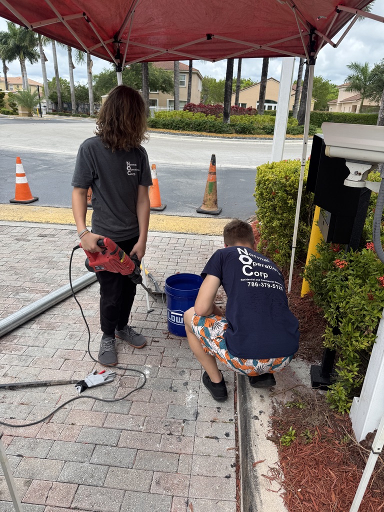 Normal Operations team drilling and preparing the site beside a community callbox