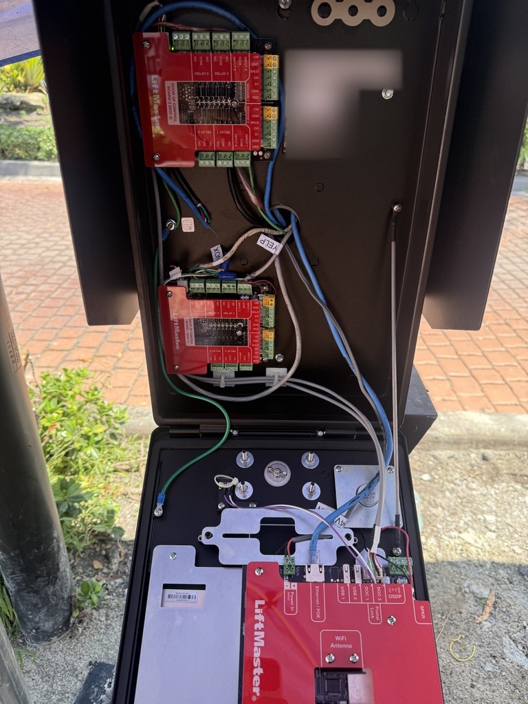 Interior of a LiftMaster callbox showing control boards and organized wiring
