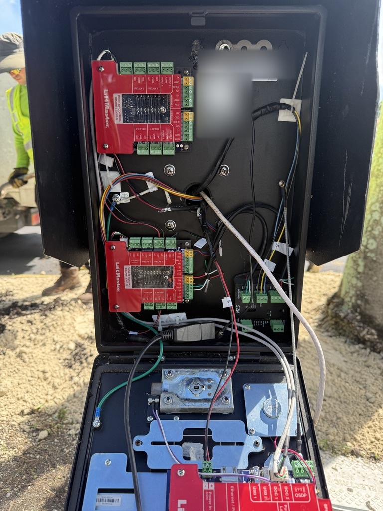 Gate operator wiring being inspected and serviced
