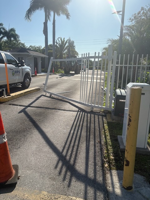 White community swing gate open during repair and alignment work