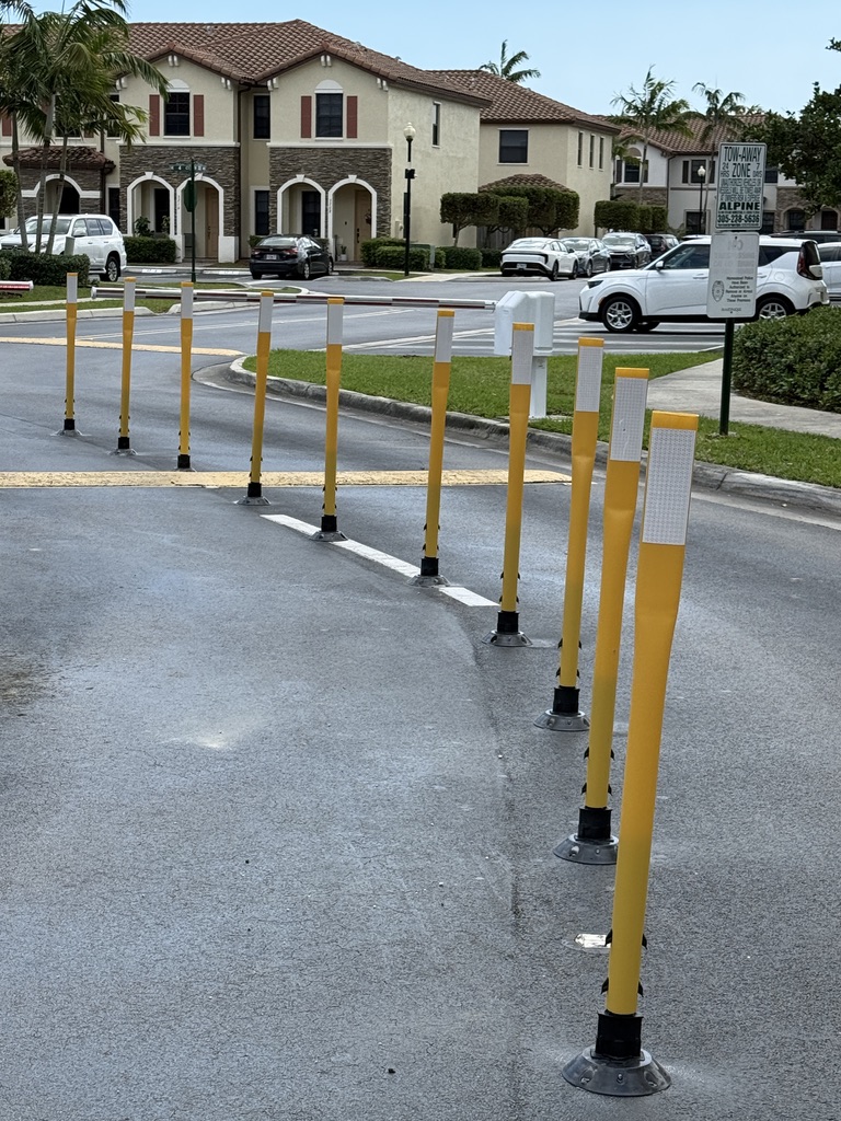 Freshly installed traffic delineator posts at a gated community